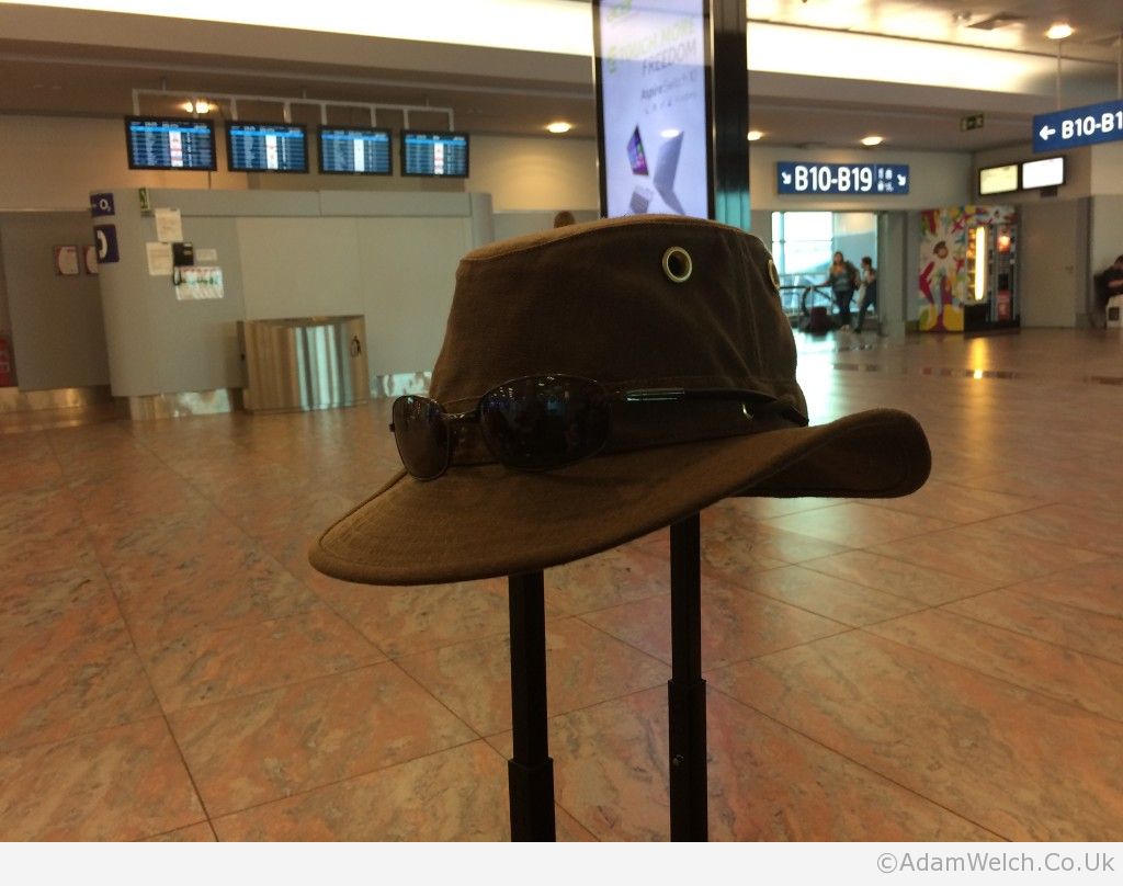 I posted practically the same picture last August. Different airport, different hat, same suit case.