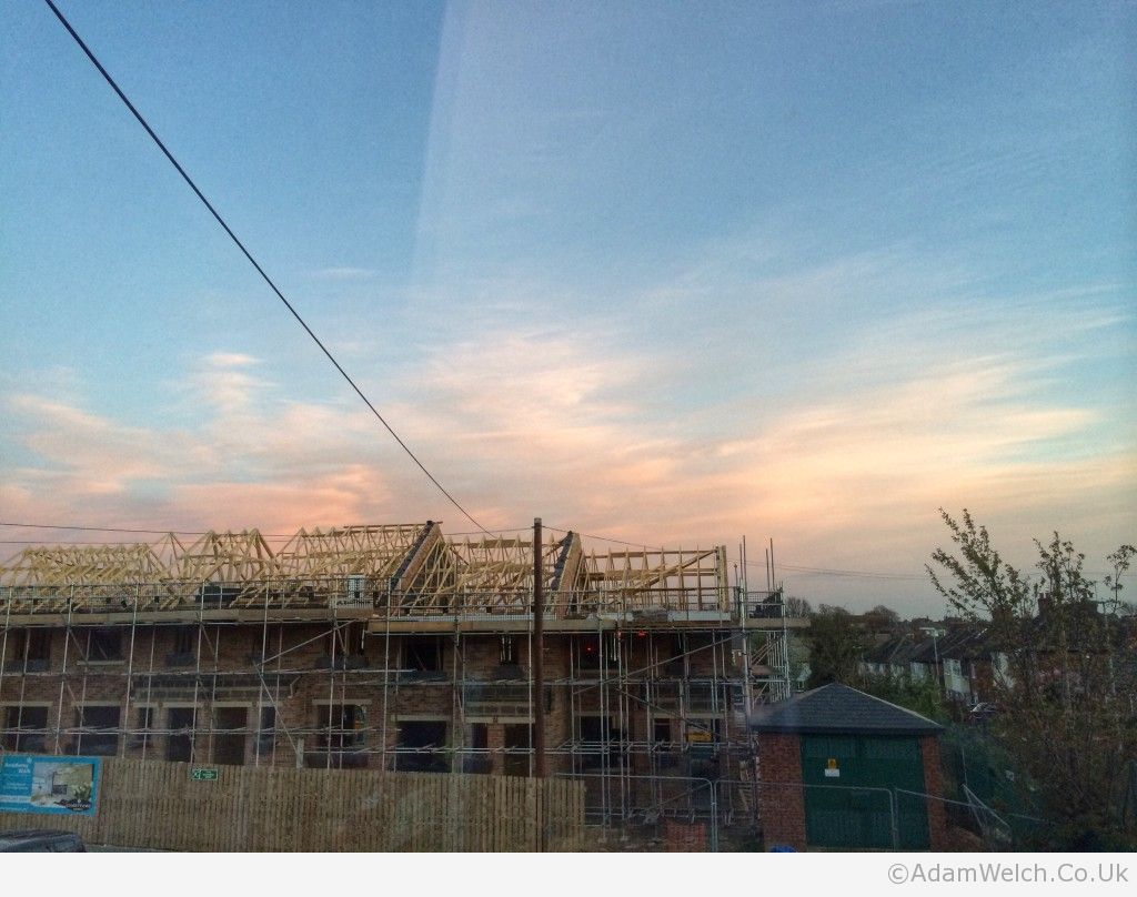 Pleasant sunset behind the building site...