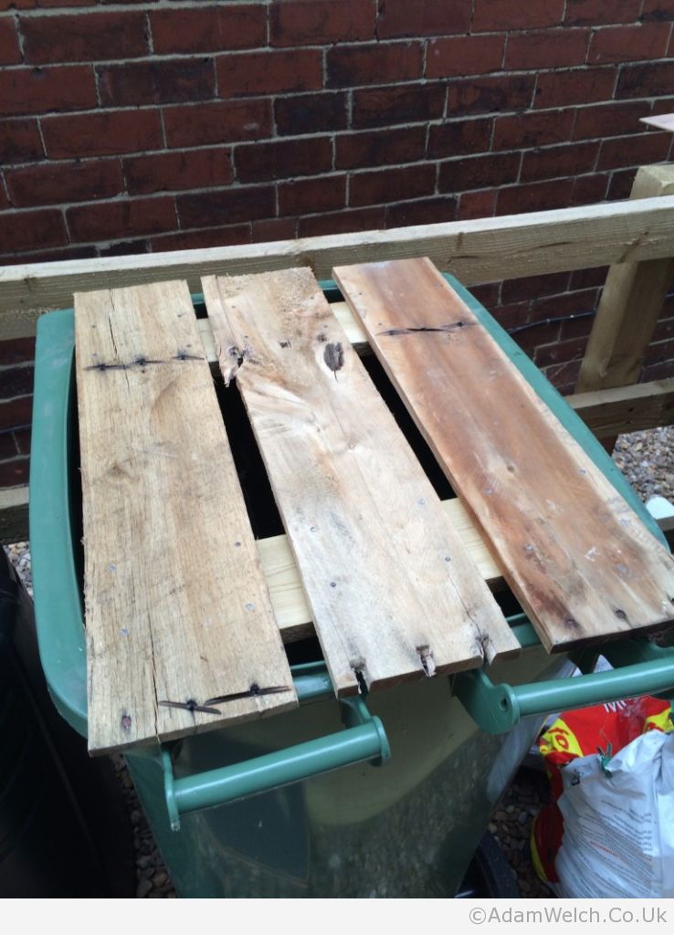 Repurposed green wheelie bin water butt now including a reclaimed wood safety lid. #recycling